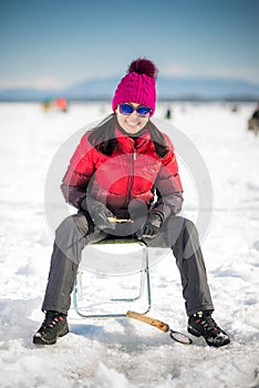 Woman ice-fishing in the winter