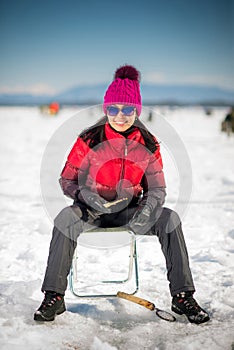 Woman ice-fishing in the winter