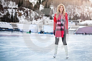Woman ice skating outdoor at ice rink stadium.