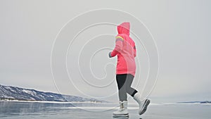 Woman on ice in winter is do sport in athletic race walking. Girl is training in winter on ice. Sports nordic power