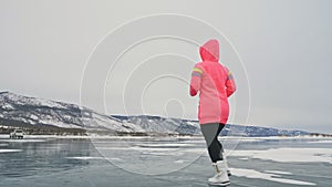 Woman on ice in winter is do sport in athletic race walking. Girl is training in winter on ice. Sports nordic power