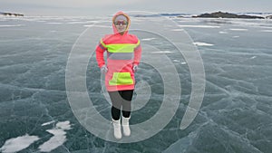 Woman on ice in winter is do sport in athletic race walking. Girl is training in winter on ice. Sports nordic power