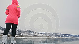 Woman on ice in winter is do sport in athletic race walking. Girl is training in winter on ice. Sports nordic power