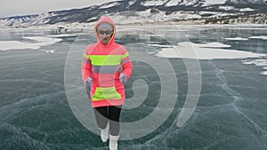 Woman on ice in winter is do sport in athletic race walking. Girl is training in winter on ice. Sports nordic power