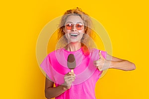 woman with icelolly ice cream in studio, thumb up. woman with icelolly ice cream photo