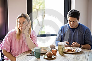 Woman ignoring boyfriend during date