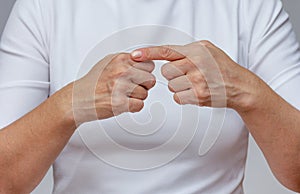 Woman index finger pointing at the first digital knuckle on hand to identifying Arthritis