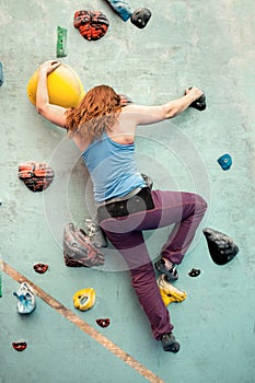 Woman Indoor Rock Climbing. Body Shape Climber Back View