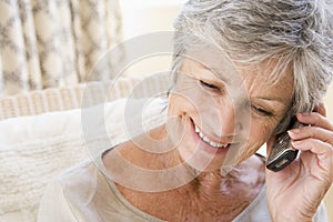Woman indoors using cellular phone