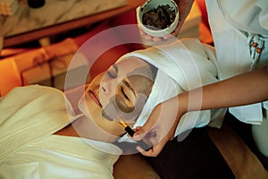 Woman indulges in rejuvenating with luxurious face cream spa massage. Quiescent