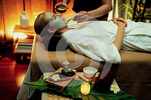 Woman indulges in rejuvenating with luxurious face cream spa massage. Quiescent