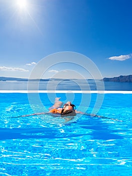 Woman at the infinity swimming pool