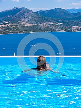 Woman at the infinity swimming pool