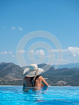 Woman at the infinity swimming pool