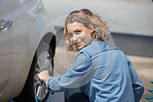 woman inflating car tyre