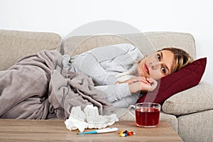 Woman with influenza on the sofa