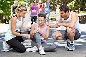 Woman with injured knee during race in park