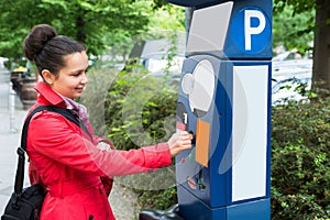 Woman Inserting Coin In Parking Meter