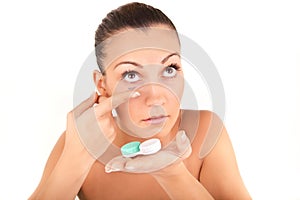Woman inserting a contact lens in her eye