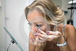 Woman, inserts a contact lens