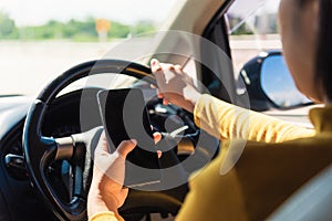Woman inside a car and using a hand holding mobile smartphone