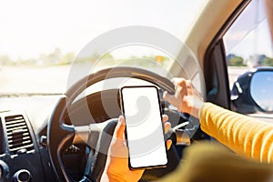 Woman inside a car and using a hand holding mobile smartphone
