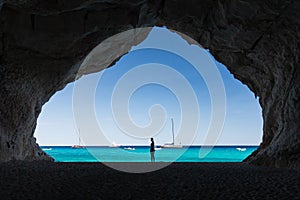 Woman inside a cave at Cala Luna beach