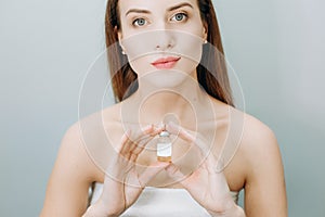 Woman insistently approves buy bottle medicine cosmetic