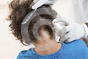 Woman inspect childs head of schoolchild for lice.