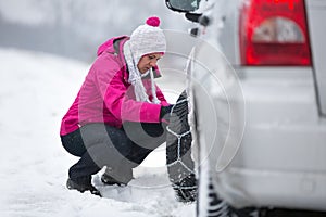 Woman installing tire chain
