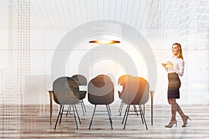 Woman in white attic dining room, long table