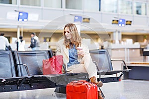 Woman at international airport waiting for flight at terminal