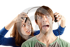 Woman interupts man with headphones