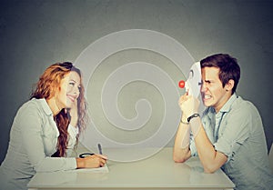 Woman interviewing new candidate for a job, a man pretender hiding his real personality