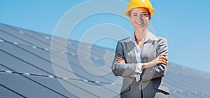 Woman investor in clean energy standing in front of solar panels