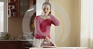 Woman Ironing Being Pissed off and Steaming a Concept of a Family Routine Shot Indoors with a Sunshine