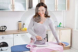 Woman Ironing Cloth With Electric Iron