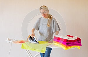 Woman ironing clothes at home