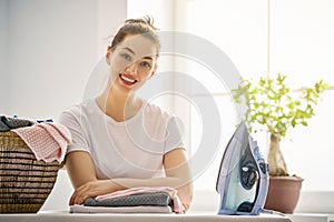 Woman is ironing at home