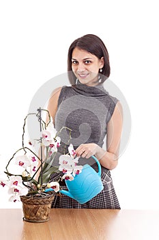 Woman irrigate orchid