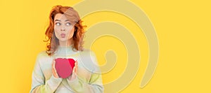 Woman isolated face portrait, banner with copy space. funny redhead girl with red heart on yellow background. valentines