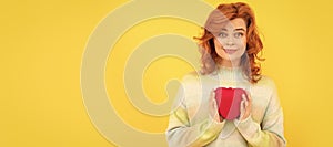 Woman isolated face portrait, banner with copy space. smiling redhead girl with red heart on yellow background.