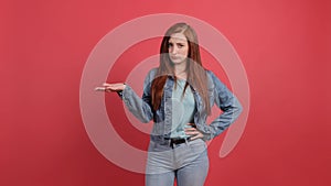 Woman isolated on red background unhappy for not understand something.