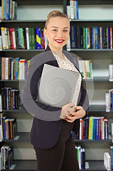 Woman in a jacket with a folder in hands