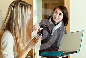 Woman in jacket polling among people