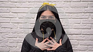 Woman in jacket in protective mask feels a sense of fear corona virus threat.