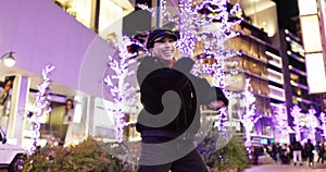 Woman in Japan, dancing in city at night with energy and fun, happiness and freedom outdoor. Celebration, party and