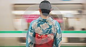 Woman, japan and train station, kimono and travel with public transport, metro bullet in city. Person, journey or