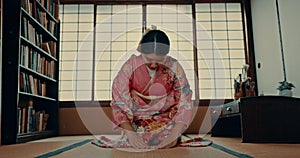 Woman, Japanese and traditional spiritual respect in Chashitsu room for ritual, gratitude or wellness. Asian person