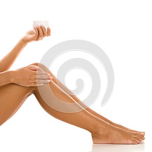 Woman with jar of body lotion